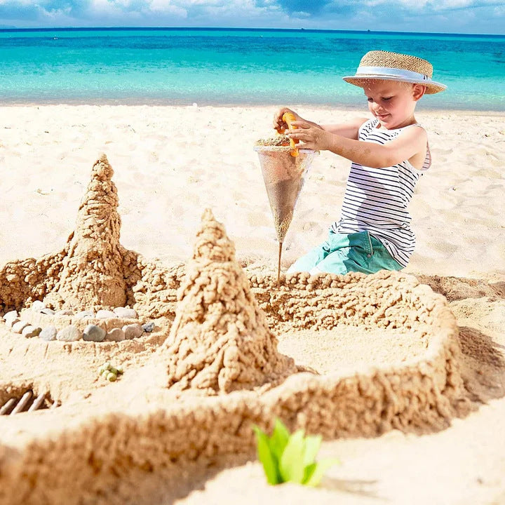Beach toys overflowing sand from funnel